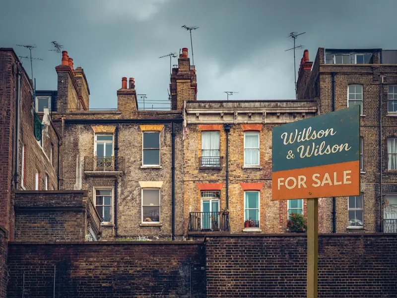 Deteriorating estate agents sign outside old Victorian flats