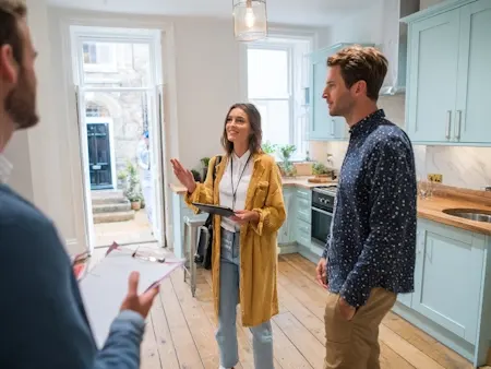 Estate agent showing prospective buyers a studio flat