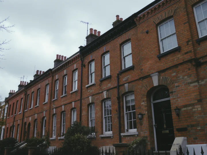 A leasehold flat owner reviewing lease documents at a desk