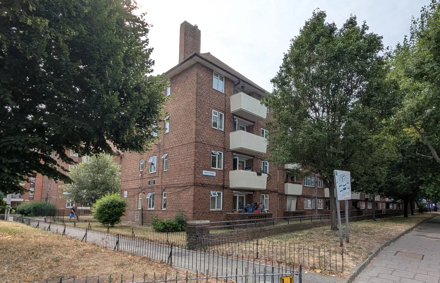 Keats House, a low-rise red-brick council block with projecting concrete balconies in SE5, south London