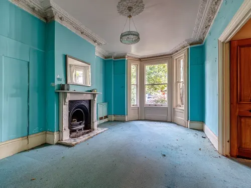 London flat in need of cosmetic improvement with blue carpets and walls
