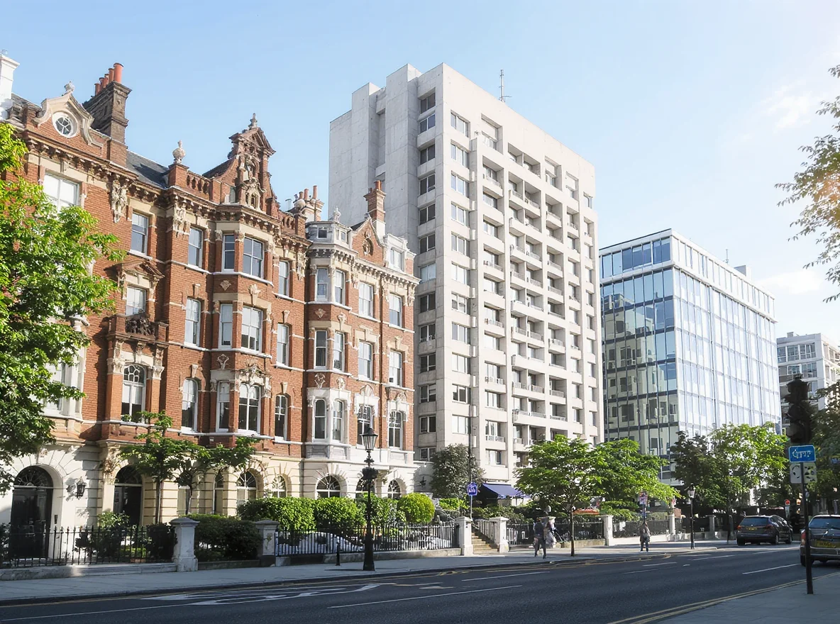 A London street with a red-brick Victorian mansion block, a pale mid-century block of flats and a modern glass-fronted apartment building side by side