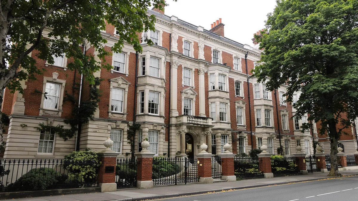 Red brick Edwardian mansion block in central London with stone dressings and rows of sash windows