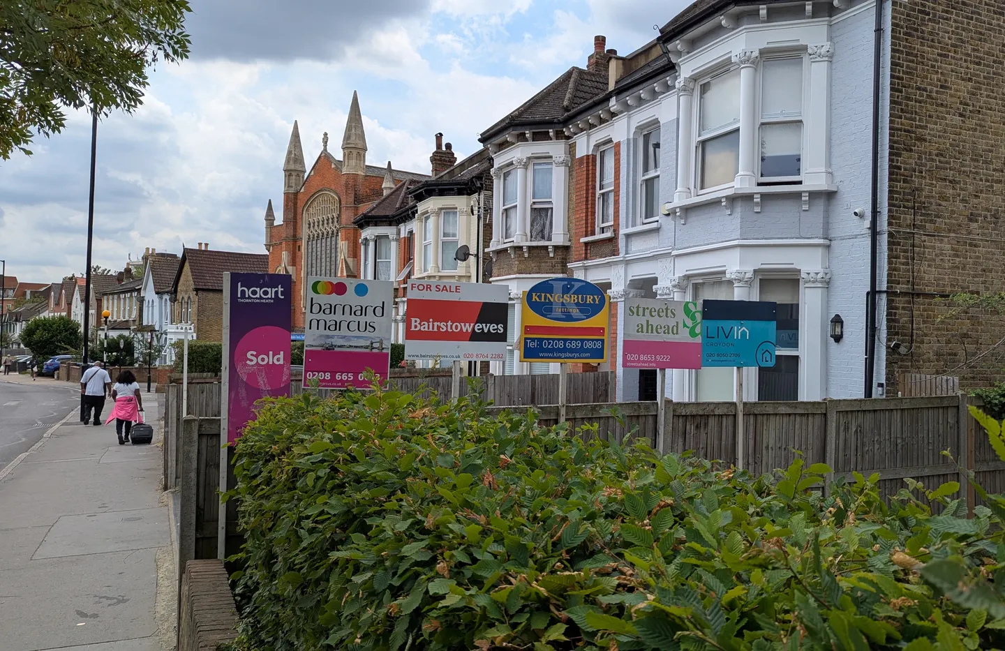 A row of estate agent Sold, For Sale and Let By boards outside Victorian flats in Thornton Heath, south London
