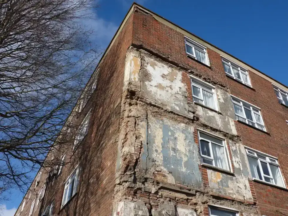 Structurally compromised block of flats with missing brickwork